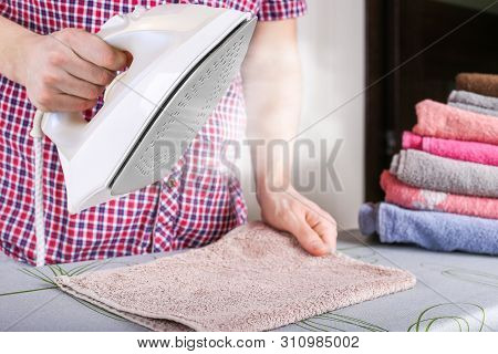 Man Ironing Clothes With Steam Function. Close Up Of Steaming In The Iron
