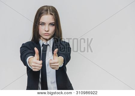 Female Hand Gestures Thumbs Up. Business Girl Is Serious And Shows Her Confidence.