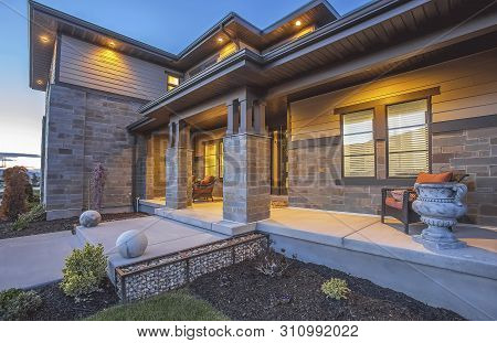 Yard And Pathway In Front Of The Porch Of A Home With Stone Brick Wall
