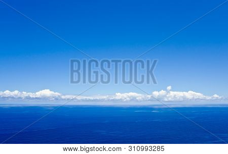 Blue Sky With Some White Clouds Above The Atlantic Ocean