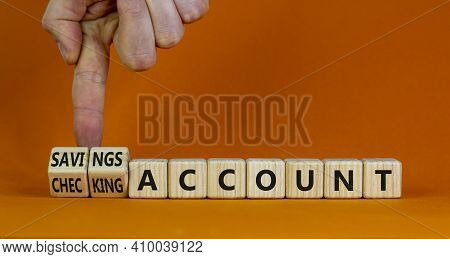 Savings Or Checking Account Symbol. Businessman Turns Wooden Cubes And Changes Words 'checking Accou