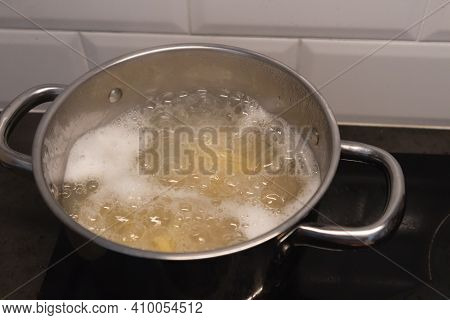 Cooking Pot On The Vitroceramic, With Boiling Water And Spaghetti
