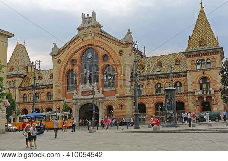 Budapest, Hungary - July 13, 2015: Central Market Hall At Fovam Square With People And Tram Public T