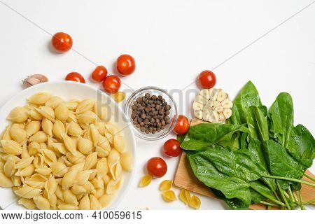 Ingredients For Oven-baked Feta Cheese With Tomatoes And Pasta, Pepper Garlic On A Light Background