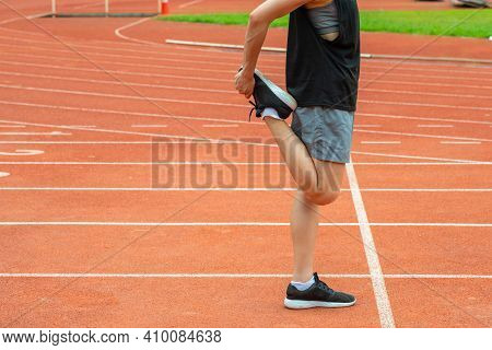 Cropped Shot View Of Runner Woman Doing Stretching And Warming Up Her Legs Before Running In The Run