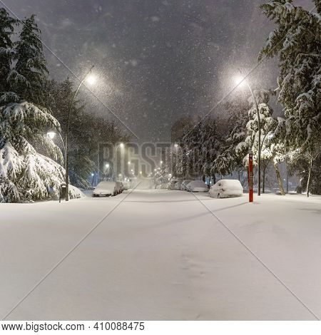 Cars And Streets Covered In Snow In Night Image Of Filomena Storm Fall In Madrid Spain. Winter