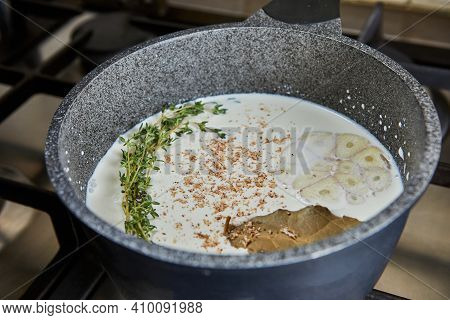 Sauce In A Saucepan Made From Cream, Garlic, Bay Leaf And Nuts