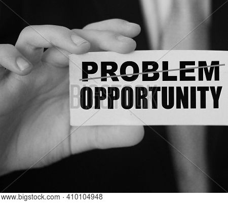 Businessman Holding A Card With Word Problem Strikeout And Opportunity. Problem Turns Into Opportuni