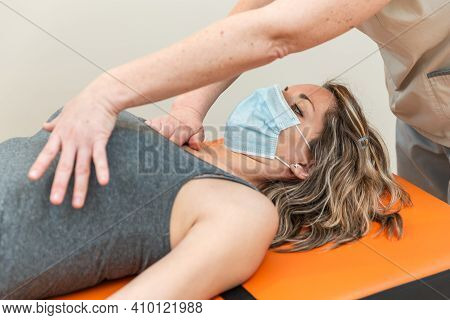 Physiotherapist And Patient In Global Postural Re-education Session, With Pandemic Protection Mask.