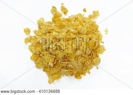 Dry Corn Flakes On A White Background Top View. Thin Cornflakes In Glaze. Quick Healthy Breakfasts.