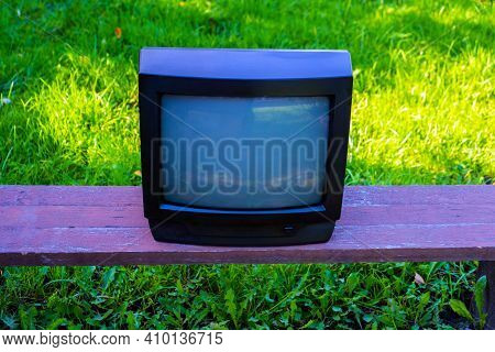 Old Analog Television Set On The Grass Background Outdoor