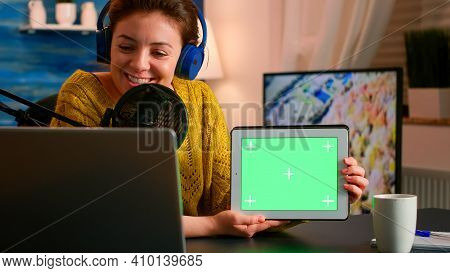 Blogger Talking Into Microphone Holding Notepad With Green Screen During Entertainment Podcast. On-a