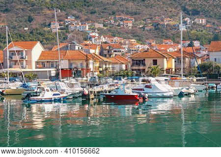 Mediterranean Town At Foot Of Mountain, Fishing Boats In Harbor. Montenegro, Adriatic Sea. Marina Ka