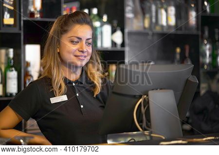 Female Bartender Registrating New Order By Cash-register. A Restaurant Worker Registrating New Order