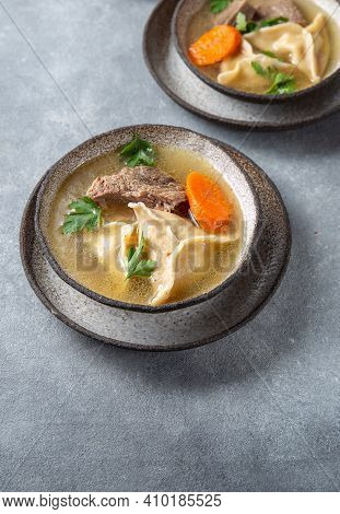 Traditional Jewish Food Dumplingd Kreplach Soup In Gray Bowl.