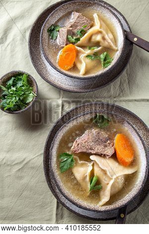 Traditional Jewish Food Dumplingd Kreplach Soup In Gray Bowl.