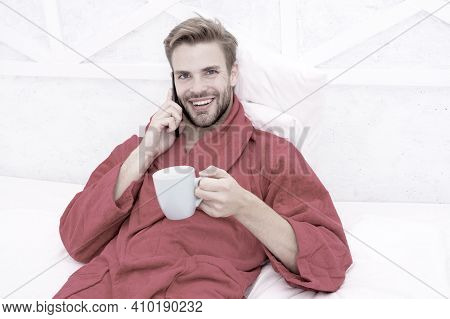 Hipster Guy Pajamas Bathrobe Freelance Worker Relaxing At Home. Remote Work Concept. Glad To Hear. M