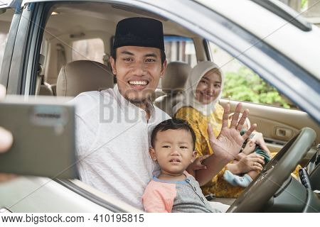Muslim Family Travel By Car And Talk Using Video Call On Their Phone