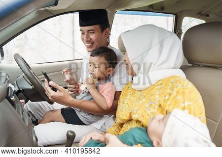 Muslim Family Travel By Car And Talk Using Video Call On Their Phone