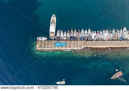 Komiza, Croatia - Aug 19, 2020: Aerial Overhead Shot Of Komiza Town Port Of Vis Island Before Sunris