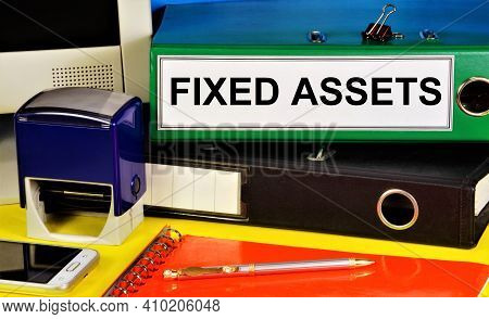 Fixed Assets. Text Label On The Folder. Material Objects That Are Used For A Long Time By The Organi