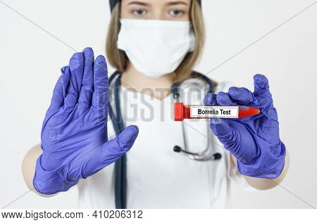 Medicine And Health Concept. The Doctor Holds In His Hands A Test Tube With Blood Tests For The Viru