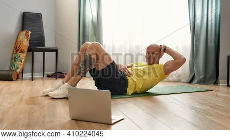Sports Coach 39 Years Old Pumping The Press While Lying On The Mat At Home. Male Trainer Performing 