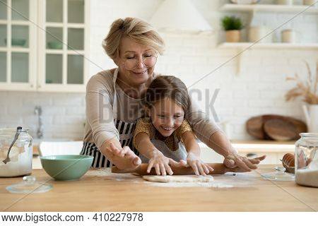 Aged Grandma Involve Small Grandkid In Rolling Dough With Pin