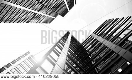 Bottom View Of Modern Skyscrapers In Business District Against Sky. Looking Up At Business Buildings