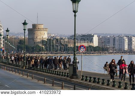 Thessaloniki, Greece - February 27 2021: People With Covid-19 Masks Before The City Landmark. Large 