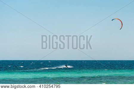 Extreme Water Sport - Kitesurfing At Sea On Hot Summer Sunny Day Copy Space. The Concept Of An Activ