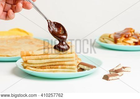 Blini Pancakes With Chocolate, Close-up On A Blue Plate On A Light Background . Traditional Russian