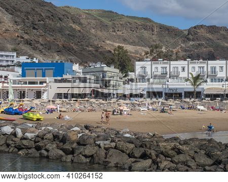Puerto De Mogan, Gran Canaria, Canary Islands, Spain December 18, 2020: View On The Public Beach Wit