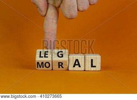Moral Or Legal Symbol. Businessman Hand Turns Wooden Cubes And Changes The Word 'moral' To 'legal' O