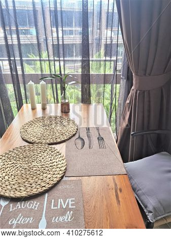 Wooden Kitchen Table With Napking And Candles