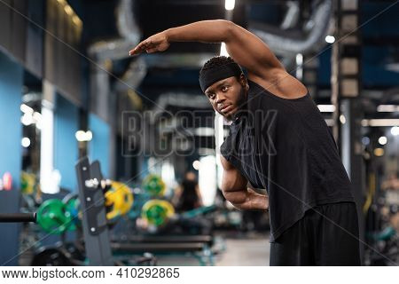 Warm Up, Limber Up, Stretching Concept. Handsome African American Bearded Sportsman Stretching His M
