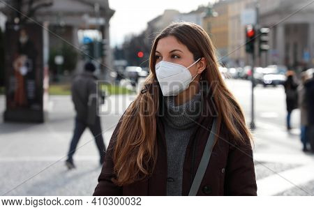 Sense Of Bewilderment. Young Woman In Winter Clothes Walking In Street Wearing Protective Mask Ffp2 