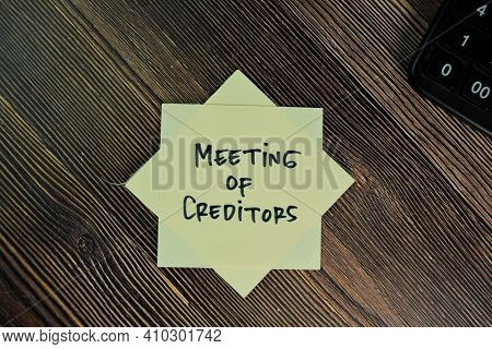 Meeting Of Creditors Write On Sticky Notes Isolated On Wooden Table.