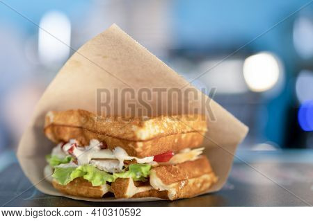 Sandwich In A Paper Bag Close-up. Sandwich Filet Americain, Close Up Of Burger. Fast, But Unhealthy 