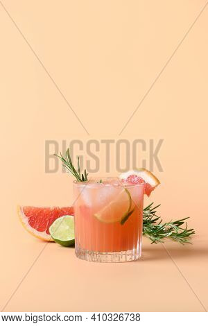 Grapefruit Soda With Lime Garnish Rosemary Sprig Isolated On Color Background. Mocktail Paloma. Clos