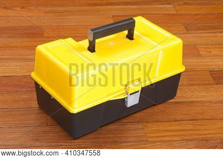 Plastic Box To Organize Tools; Photo On Wooden Background.