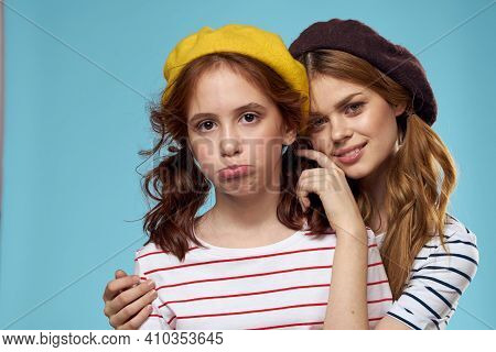 Mom And Daughter Striped T-shirts Hugs Fun Lifestyle Blue Background
