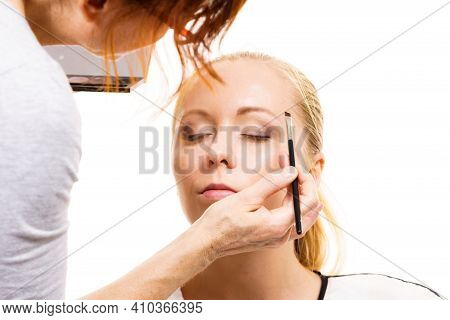 Two Women, Face Painting. Makeup Artist Applying Make Up To Model Face. Cosmetic Beauty Procedures, 