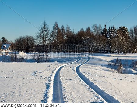 Beautiful And Inspiring Winter Landscape Of Snowy Field And Trees Covered With Snow And Single Car T