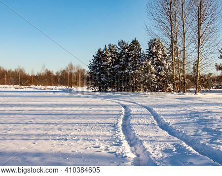 Beautiful And Inspiring Winter Landscape Of Snowy Field And Trees Covered With Snow And Single Car T
