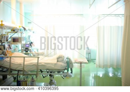 Hospital Emergency Room With Unconscious Patients In Their Beds, Unfocused Backgound.