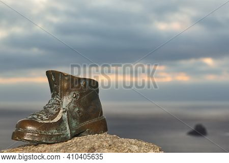 Finisterre Cape Viewpoint At Sunset With Hiker Boot Mark. Pilgrimage