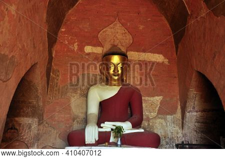 Bagan, Myanmar - November 18, 2015: Huge Colored Statue Of Buddha In Temple, From Below Shot Of Colo