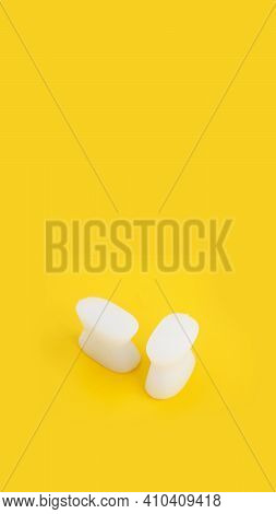 White Silicone Finger Divider On A Yellow Background. Prevention And Treatment Of Hallux Valgus. Ver