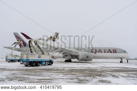Ukraine, Kyiv - February 12, 2021: De-icing The Aircraft Before The Flight. The Deicing Machine. Pas
